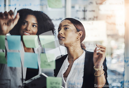 Image of Writing, schedule and meeting by business women planning agenda or calendar and sticky note in office. Teamwork, management and female person team collaboration for solution, strategy and mission