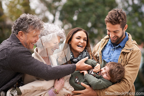 Image of Happy family, child and people playing with kid in a park on outdoor vacation, holiday and excited together. Grandparents, happiness and parents play with kid as love, care and bonding in nature
