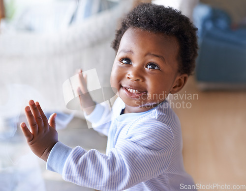 Image of Happy black baby boy, childhood development and child with smile standing against window at family home. Happiness with African male toddler, growth and young cute kid at house with childcare