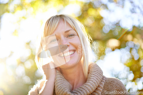 Image of Women, face and smile portrait outdoor in nature with trees, happiness and lens flare in spring. Female model person happy about travel, adventure and holiday in countryside or park for peace