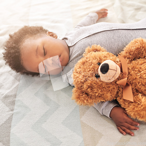 Image of Sleeping, teddy bear and cute with baby in bedroom for carefree, development and innocence. Dreaming, relax and comfortable with african infant and toy at home for morning, resting and bedtime