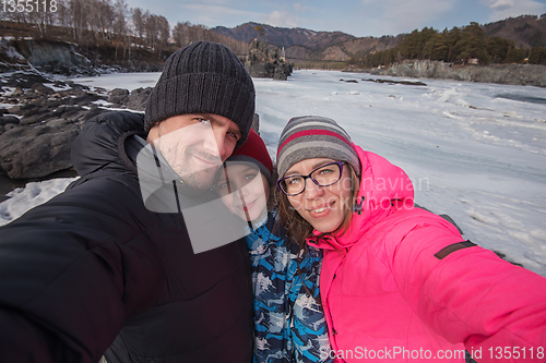 Image of Family selfie at winter journey.