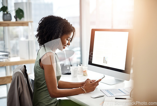 Image of Black woman, smartphone and office smile at desk for social media, communication and typing text. Female business person at computer screen, contact and notification with meme, internet and app