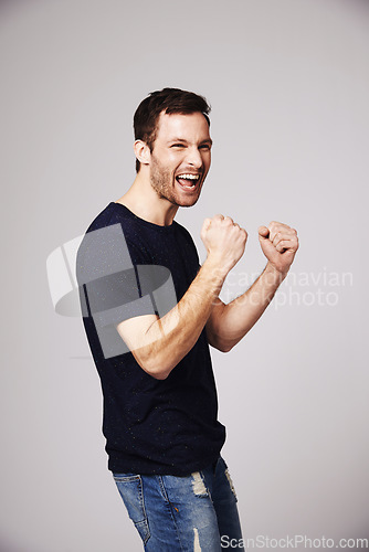 Image of Winner, celebration and man cheer with success in studio for good news, winning and achievement. Celebrate, happy and excited male person on white background for victory, announcement and cheering