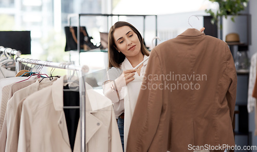 Image of Shopping, retail and a woman customer in a mall boutique to buy trendy clothes for seasonal fashion. Search, store and sale with a young female consumer in a shop, making a clothing purchase choice