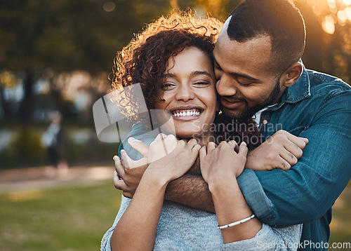 Image of Love, hug and couple in park, smile and joy with romance, bonding and relationship with happiness. Portrait, partners or man with woman, embrace, outside or marriage with wellness, loving or carefree