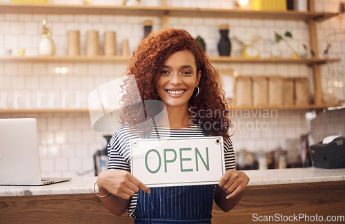 Image of Portrait, woman and smile with open sign in cafe, shop and store for retail trading time, board and advertisement. Happy restaurant owner opening small business with signage, information and welcome