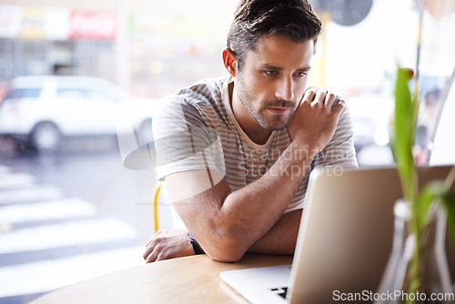 Image of Laptop, thinking and man freelancer working in a restaurant as remote work in a cafe or coffee shop and reading an email. Internet, website or serious male person or consumer blogging online in store