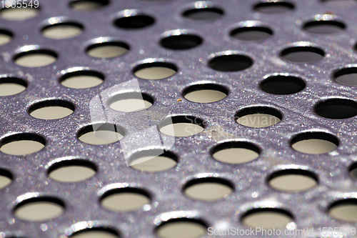 Image of Aluminum sheet drilling small holes.The surface of the material is drilled into small holes.dots wallpaper.abstract metal background with holes.