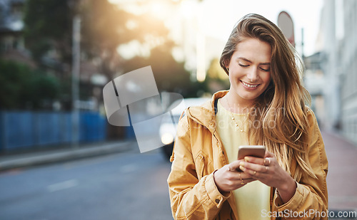 Image of Woman, smile at smartphone with communication while in city, chat on social media and connectivity outdoor. Happy young person and student in urban street, text contact with mobile app and technology