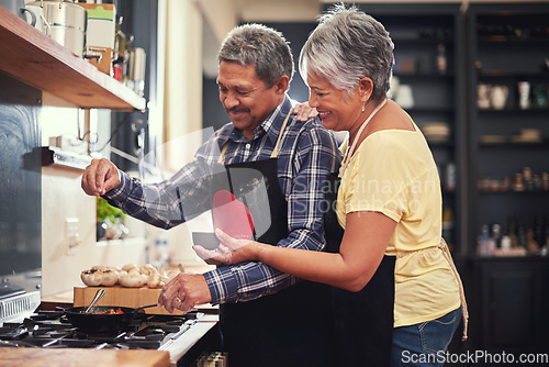 Image of Food, happy senior couple cooking in kitchen and at their home. Collaboration or teamwork of partners, family or marriage and smiling people baking or preparing a meal together in their house