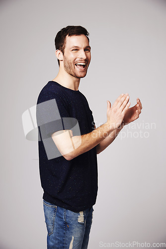 Image of Winner, celebration and man clapping with success in studio for good news, winning and achievement. Celebrate, happy and excited male person on white background for victory, announcement and cheering