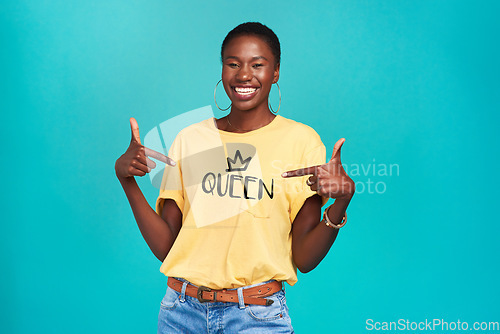 Image of Queen, print and tshirt on a black woman for equality and human rights isolated in a blue background studio. Fashion, fearless and African gen z or female person happy with quotes in her clothes