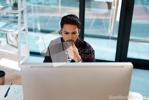 Image of Serious, computer and a business man thinking while working at a desk and online for research. Male entrepreneur person confused while reading email or data analytics with internet connection