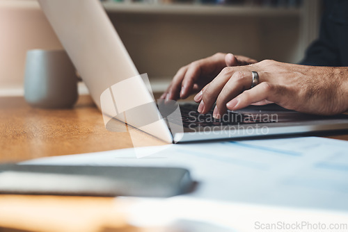 Image of Hands, closeup and man with laptop in home office for finance, review or budget planning. Fingers, keyboard and male person paying bills online for savings, investment and mortgage or startup loan