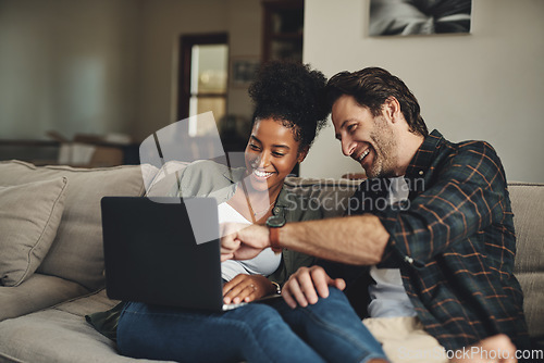 Image of Laptop, interracial and entertainment with a couple watching a video using an online subscription service to relax. Computer, streaming or internet with a man and woman bonding together over a movie