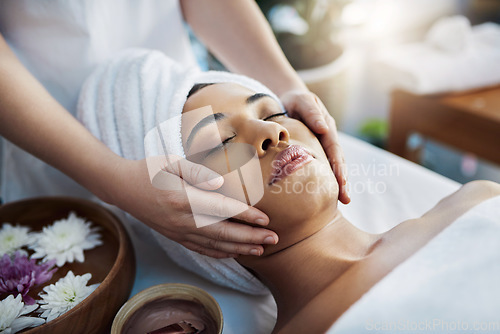 Image of Woman, hands and face massage for skincare, relax or beauty spa treatment on bed at resort. Calm female relaxing with eyes closed or resting for physical therapy, healthy wellness or cosmetic facial