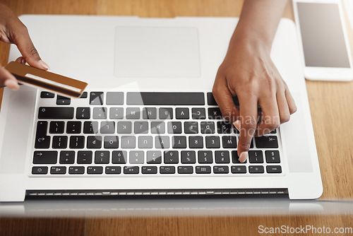 Image of Woman, hands and credit card payment on laptop for online shopping, ecommerce or internet store. Above hands of a female entrepreneur typing at desk for business banking, booking or fintech website