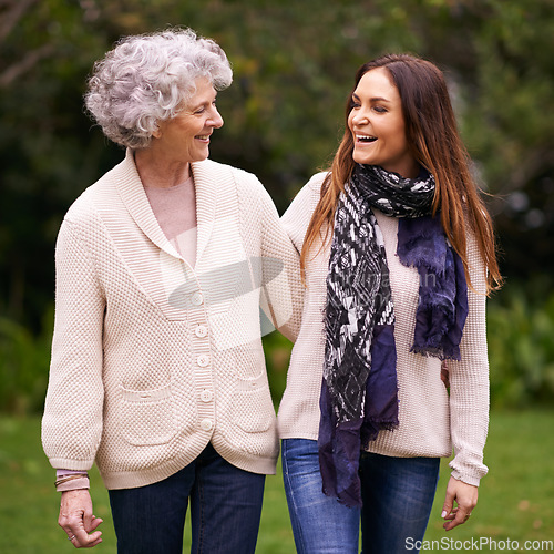 Image of Smile, park and woman with elderly mother together on a outdoor vacation or holiday bonding in happiness. Retirement, women and young happy female person in conversation and laughing with mom