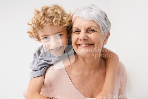 Image of Piggyback, portrait and grandmother with child embrace, happy and bonding against a wall background. Love, face and senior woman with grandchild having fun, hug and enjoying the weekend together