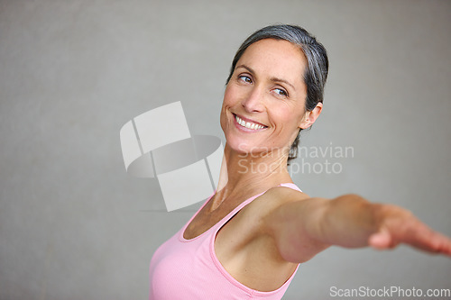Image of Senior woman, fitness and arm stretching for yoga in studio with mockup for health, balance and exercise on wall background. Stretch, meditation and mature lady smile with zen for workout or training