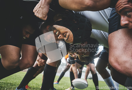 Image of Sports, rugby and players in a scrum on a field during a game, workout or training in a stadium. Fitness, performance and group of athletes in position on an outdoor grass pitch for match or practice