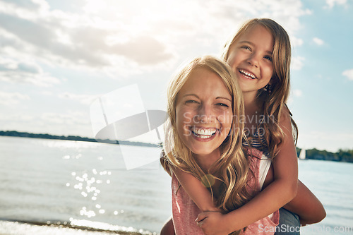 Image of Family, children and a mother with her daughter on the beach during summer for bonding on vacation. Portrait, love and kids with a woman carrying a female child on her back on the coast by the ocean