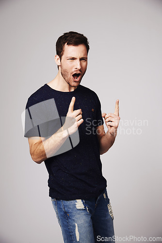 Image of Winner, excited and man with celebration for success in studio for good news, winning and achievement. Celebrate, happy and male person on gray background for victory, announcement and cheering