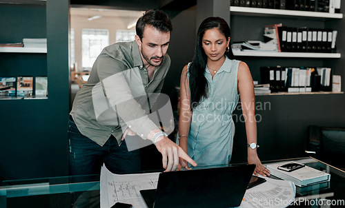 Image of Laptop, people with construction paper of plan on desk and architecture in modern office. Engineering, teamwork or collaboration at work and coworkers planning or development with blueprint.