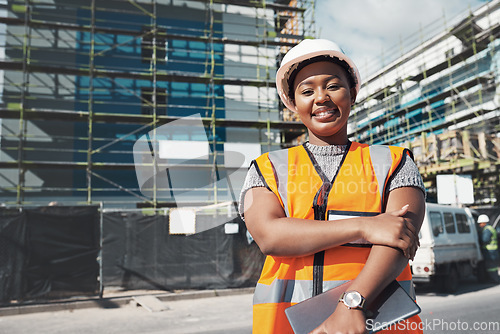 Image of Engineer, construction site and portrait of a black woman outdoor for development and architecture. African female contractor happy about building project, engineering and safety inspection in city