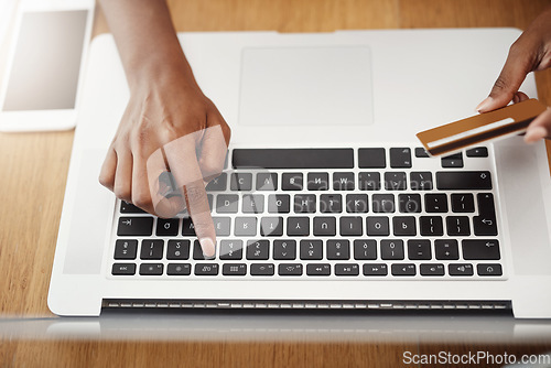 Image of Hands, laptop and payment with credit card for online shopping, e-commerce or internet store. Closeup of female entrepreneur at desk with keyboard for banking, booking or fintech website for business