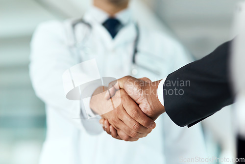 Image of Closeup, doctor or man with handshake, negotiation or planning with partnership, healthcare or wellness. Medical professional, consultant or employee with an offer, support or teamwork with promotion
