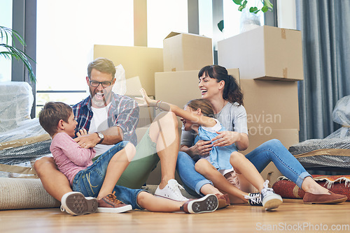 Image of Happy, family and moving with boxes in apartment on the floor are excited with the mortgage. Parents, children and new home for investment are playful with box in the living room of property.