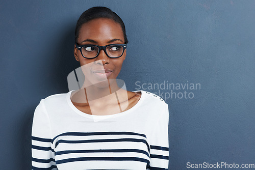 Image of Happy, thinking and black woman with glasses, ideas and thoughtful against a blue studio background. Female person, lady and girl with eyewear, clear vision and thoughts with decision and opportunity