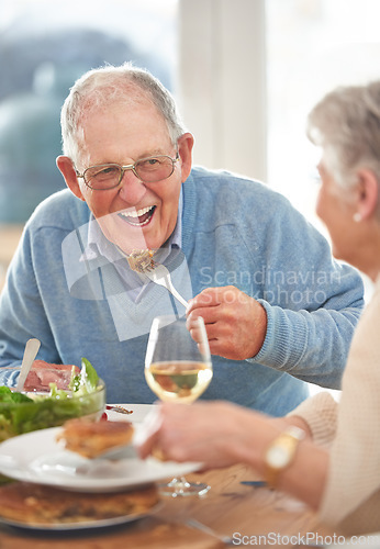 Image of Happy, love and elderly couple eating lunch together in the dining room of their modern home. Happiness, smile and senior man and woman in retirement talking, bonding and enjoying meal in their house