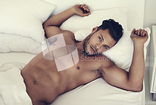 Image of Portrait, naked and man in a bed in the morning, fitness and muscular at home, serious and confident. Face, male person and guy in the bedroom, muscle and sexy with wellness, nude and shirtless