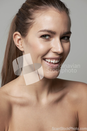 Image of Happy, beauty and portrait of woman in studio for wellness, facial treatment and self care. Dermatology, skincare and face of female person with natural cosmetics, makeup and smile on gray background