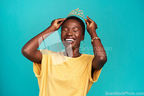 Image of Crown, happy and excited princess or black woman with happiness isolated in a blue background studio. Celebration, winner and young female person celebrating with a tiara for an achievement or prom