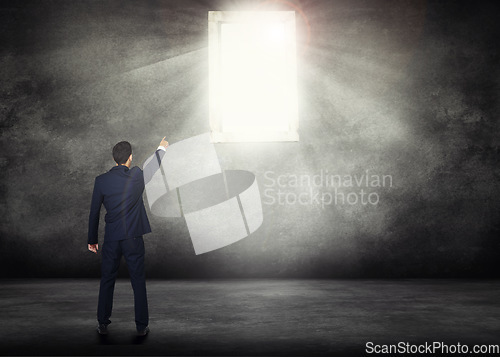 Image of Back, opportunity and a business man with window light for access on a dark background with mockup. Wall, career and male professional and CEO pointing the way to future growth, success or leadership