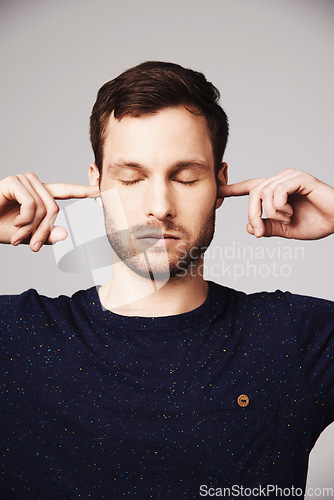 Image of Man, quiet and block ears in studio with thinking, peace and mindfulness to relax by white background. Isolated guy, model and fingers to stop noise, focus and mindset with memory, idea and backdrop