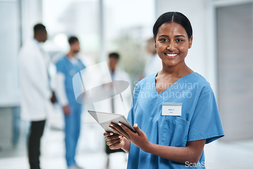 Image of Medical, doctor face and woman with tablet in a clinic reading healthcare and wellness data at hospital. Employee, nurse and Indian person with digital and online results on technology with research