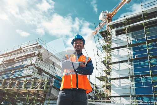 Image of Engineer, construction and portrait of a black man at building site for development and architecture. Male contractor happy about project management, engineering and safety inspection outdoor in city