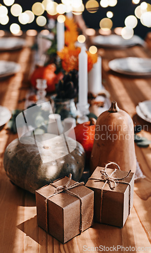 Image of Pumpkin, thanksgiving and holiday celebration or table in a home dining room with decoration for a party. Season, art and gift background with vegetable, candles and rustic dinner inspiration