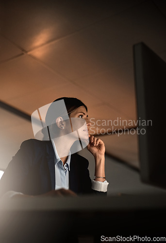 Image of Thinking, concentration and woman in office at night reading email, proposal or online report at start up agency. Corporate overtime, challenge and focus, businesswoman at desk working late on ideas.