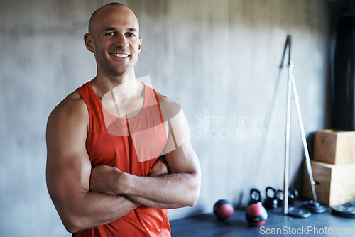 Image of Happy man, fitness and portrait with arms crossed in confidence for workout, exercise or training at gym. Strong muscular and fit bodybuilder with smile for confident bodybuilding, health or wellness