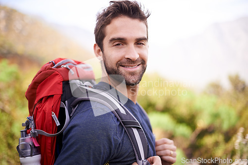 Image of Hiking, smile and portrait of man on mountain for fitness, adventure and travel journey. Backpacking, summer and workout with male hiker trekking in nature path for training, freedom and explore