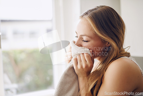 Image of Cleaning, housekeeping a woman smelling laundry in her home while washing fresh linen in the living room. Fabric, scent and happy with a female cleaner or housekeeper doing chores for hospitality