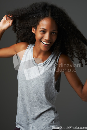 Image of Portrait, african woman and smile in studio with confidence, good mood and positive personality. Happy female model, beautiful afro hair and casual style for natural beauty, fashion and empowerment