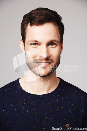 Image of Man, portrait and smile of a happy person with confidence and casual style in a studio. Isolated, gray background and face of a male model and young person with modern fashion and stylish clothes