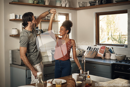 Image of Happy couple, dance and fun bonding in kitchen for romance, love or holiday together at home. Interracial man and woman dancing in happiness for romantic relationship or enjoying weekend in the house